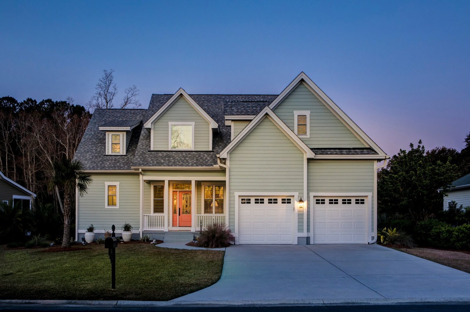 Front elevation of beautiful home lit up at twilight.