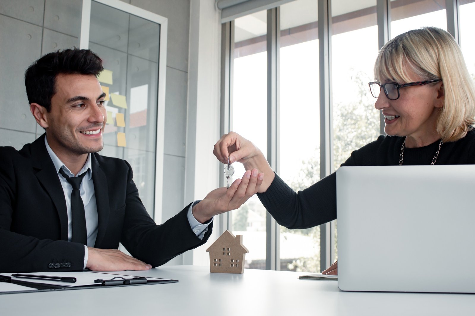 Men are receiving key home after buying a home success.